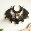 Black gothic bat moon floating wall decor featuring amethyst and rose quartz crystals on a wooden shelf