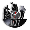 A black silhouette of a jazz musician playing a saxophone is displayed on a vintage vinyl record wall clock.
