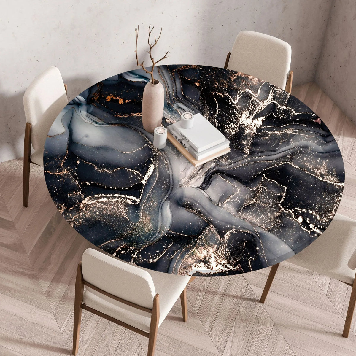A round table set for dining featuring a dark blue and gold marble print tablecloth on a wooden table.