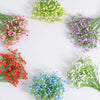 A circular arrangement of artificial baby's breath flowers in various shades of pink, purple, yellow, and green.