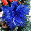 Blue glitter artificial poinsettia flowers used as Christmas décor on a green wreath.