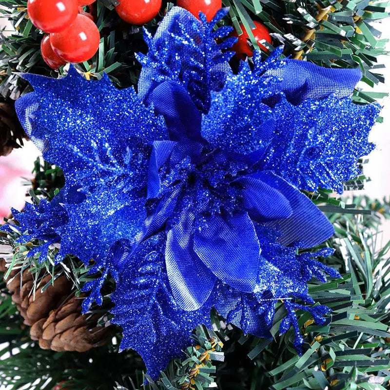 Blue glitter artificial poinsettia flowers used as Christmas décor on a green wreath.