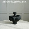 A black, textured Nordic modern vase is shown on a white surface.