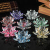 A collection of colorful crystal lotus flower ornaments displayed on a dark surface.