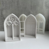 White silicone molds shaped like gothic church windows for crafting