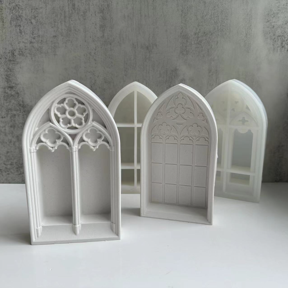 White silicone molds shaped like gothic church windows for crafting