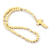 A necklace made of light wood beads with a gold crucifix pendant.