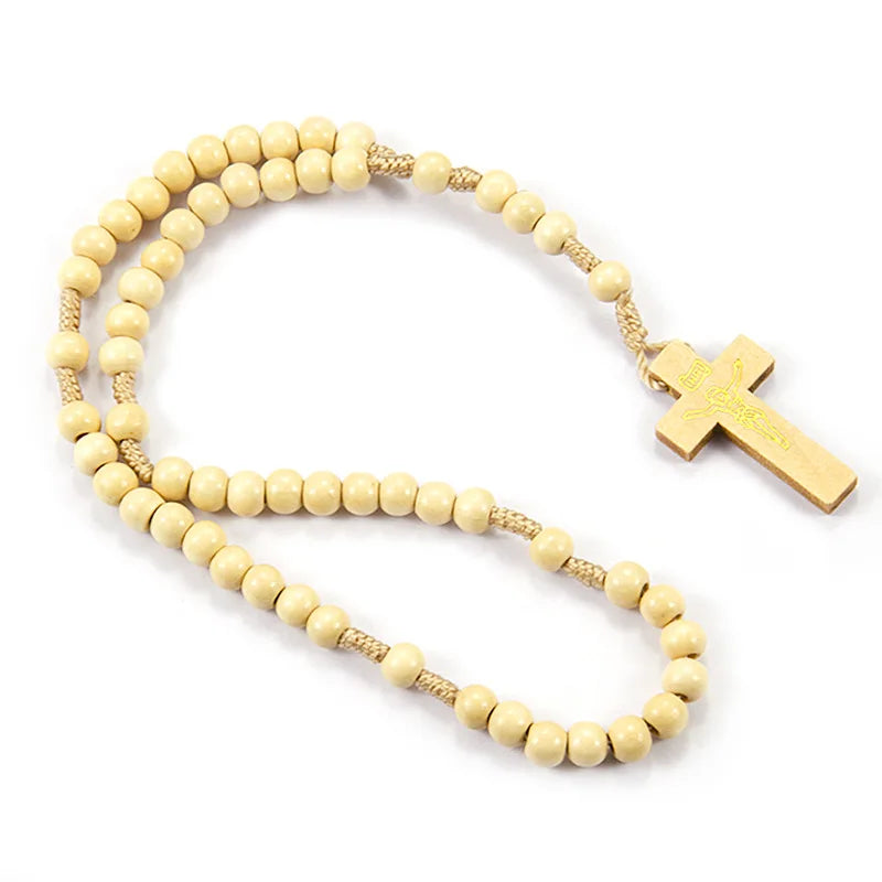 A necklace made of light wood beads with a gold crucifix pendant.