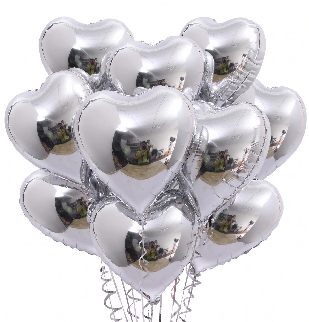 A bunch of silver heart-shaped foil balloons filled with photos, tied together for decoration.