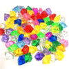 A pile of colorful crystal ice cube acrylic stones in various shades of red, blue, green, yellow, and purple.