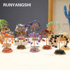 A display of seven crystal trees, each featuring natural stones in various colors like orange, purple, and green.