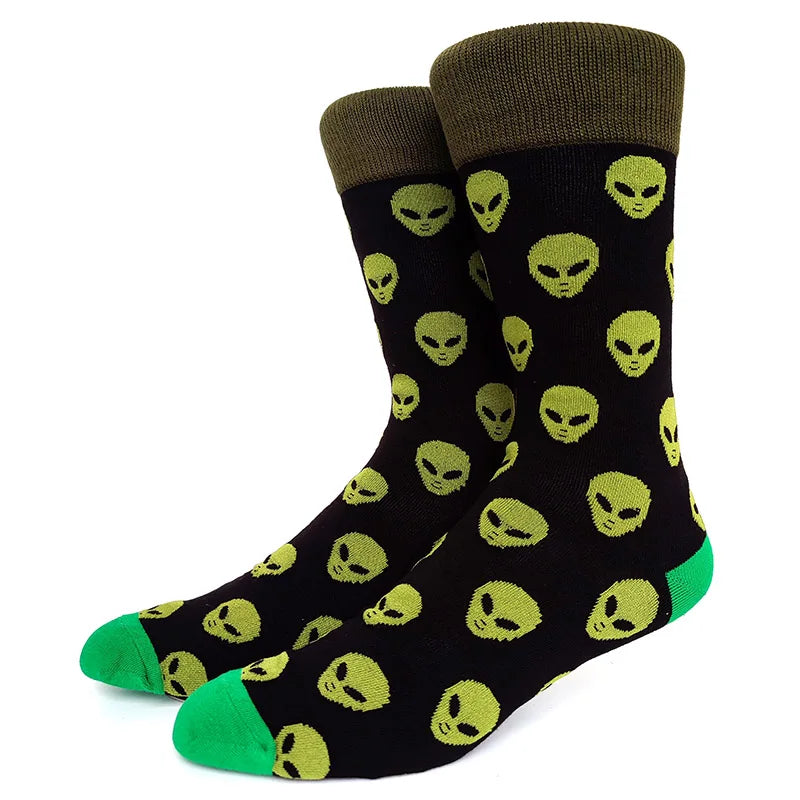 A pair of black crew socks featuring a repeating pattern of green alien skulls.