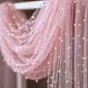 Pink pearl gauze decorative table flag with beaded trim draped on a hanger