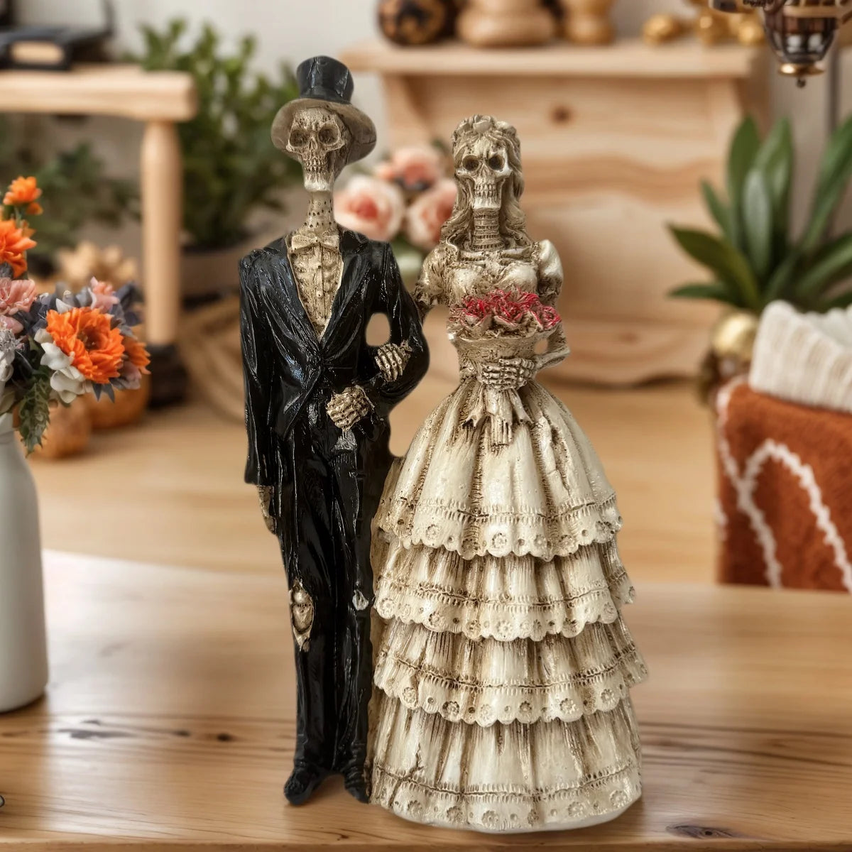 A resin figurine depicting a gothic skeleton couple, featuring a black and white dressed figure.