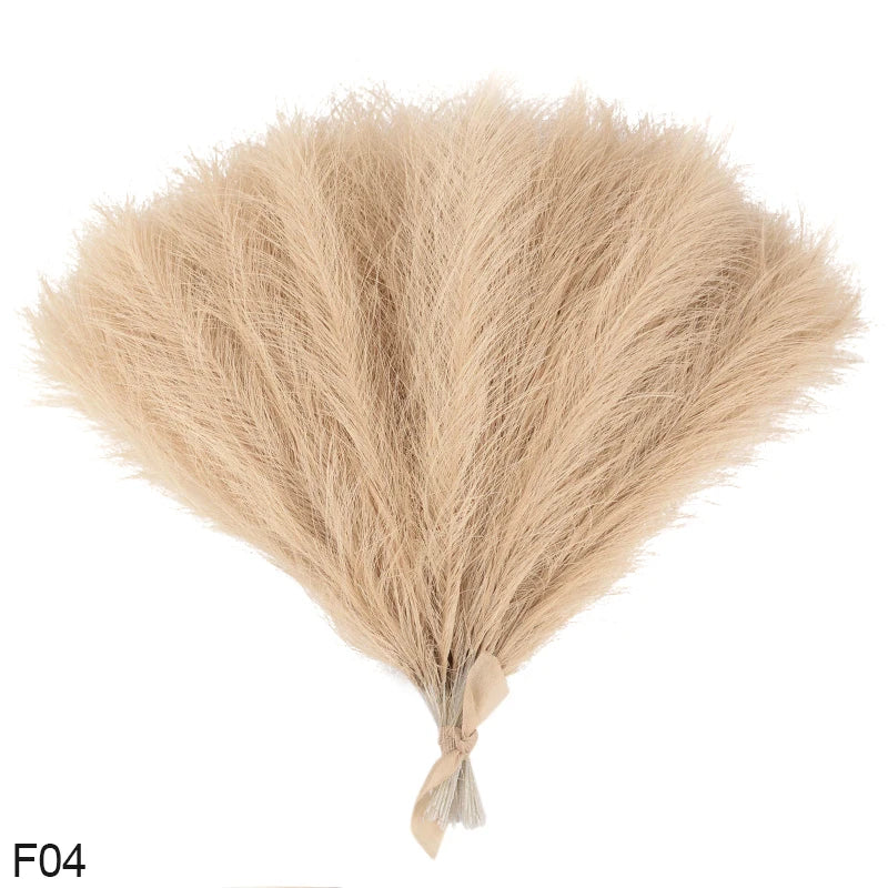 A bundle of light beige artificial pampas grass reeds used for home and event decor.