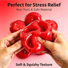 Hands hold a red watermelon slushy squishy fidget toy showing its soft and squishy texture.