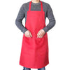 A person wearing a red waterproof kitchen apron over a gray sweater.