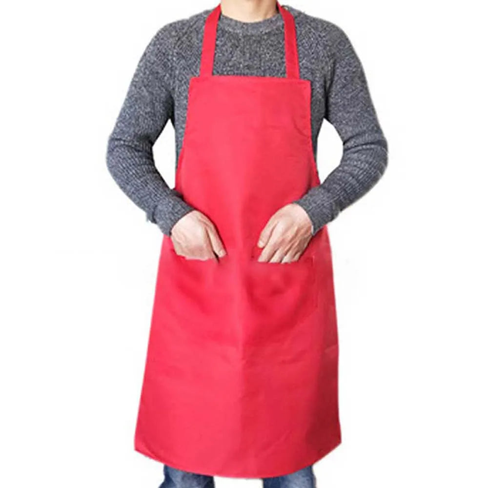 A person wearing a red waterproof kitchen apron over a gray sweater.