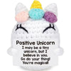 Handmade crochet unicorn doll with colorful horns and a positive message card