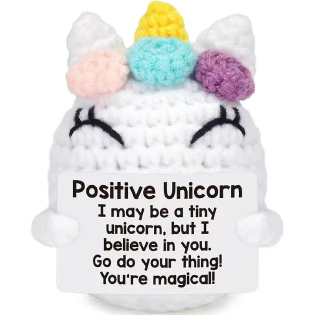 Handmade crochet unicorn doll with colorful horns and a positive message card