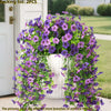 A dense archway of purple and pink faux silk flowers used for outdoor garden decoration.