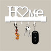 A letter-shaped metal wall key holder with four hooks displaying various keys and a small charm.