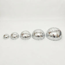 A set of five silver disco balls with adhesive backing arranged in a row.