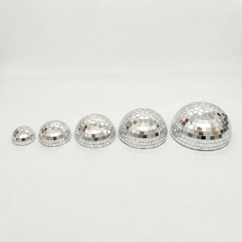 A set of five silver disco balls with adhesive backing arranged in a row.