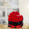 A large bouquet of red roses in a black box with a red ribbon, shown against a light background.