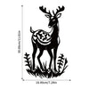 Black metal deer head wall sculpture with antlers standing in grass.