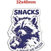 A purple and white illustration of a fox head with the text MAKE ME NICER on an acrylic charm.