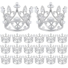 A collection of silver-toned mini pearl crown cake toppers for weddings and parties.