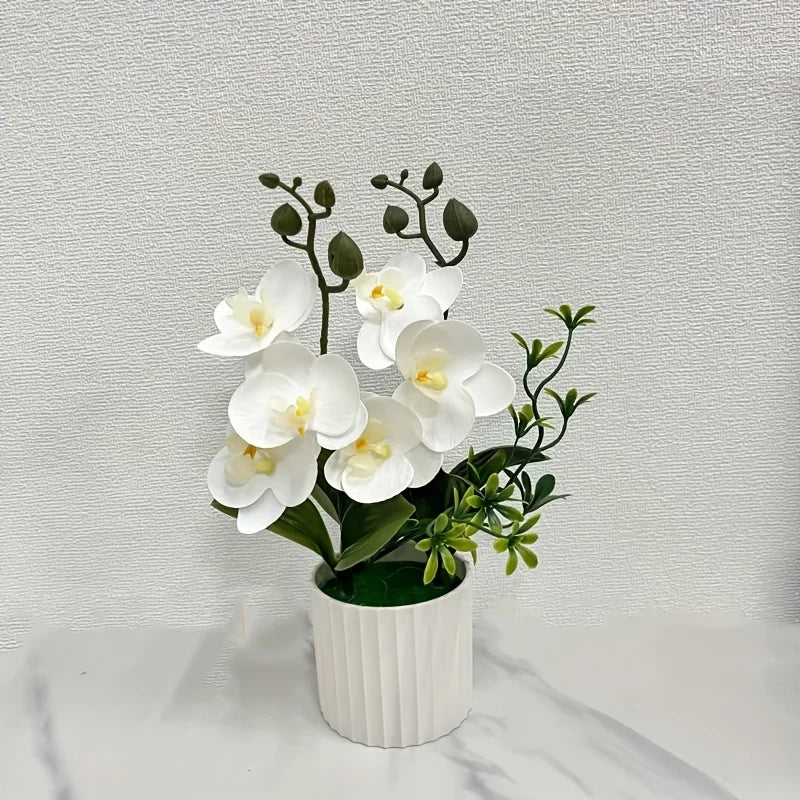 Artificial white phalaenopsis orchid in a cylindrical pot displayed against a white background.