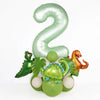 A large, light green foil number 2 balloon surrounded by various dinosaur-themed balloons.