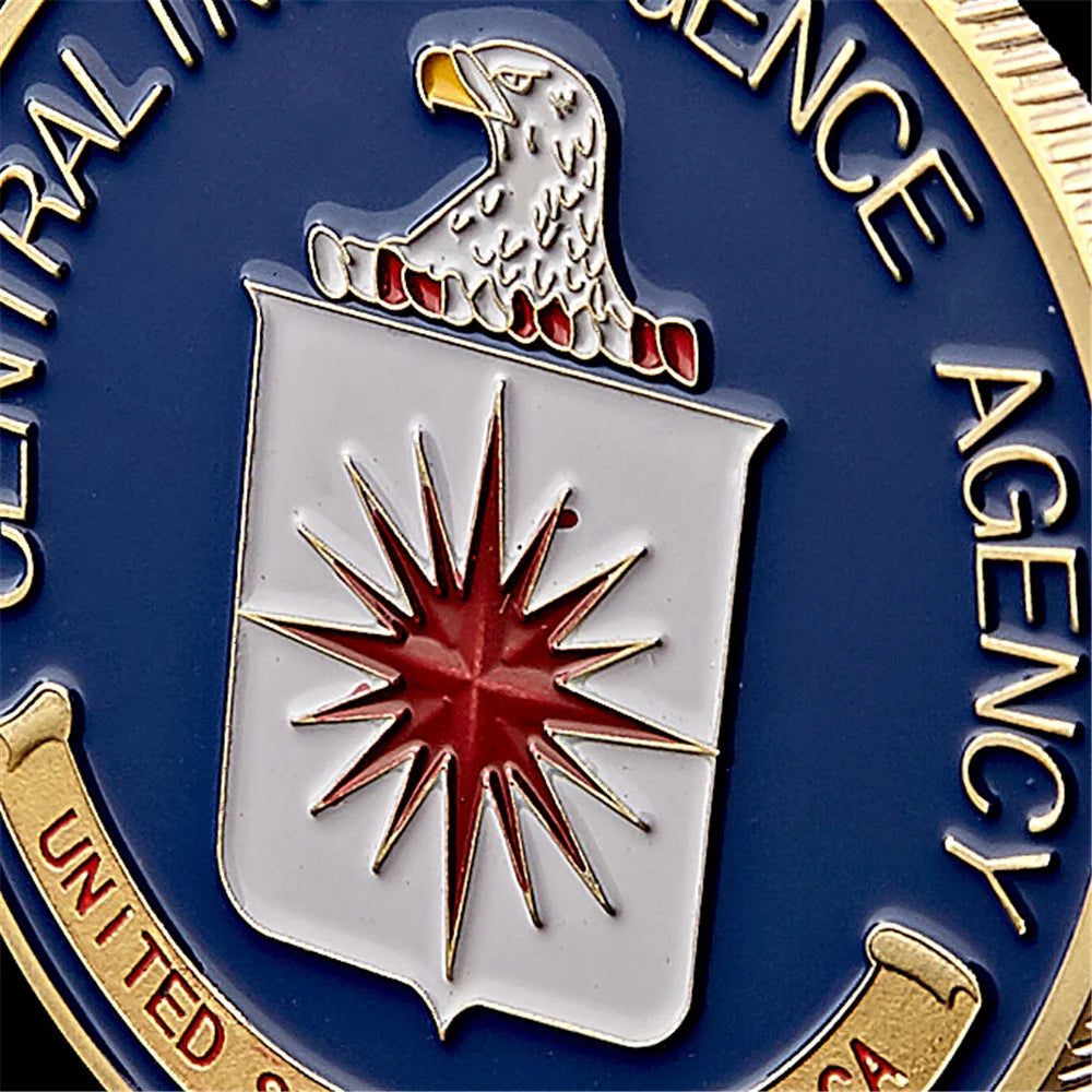 Gold-plated CIA challenge coin featuring an eagle crest and a star design on a blue background.