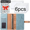 A set of six white stickers and a tan leather planner binder with cash envelopes and expense sheets