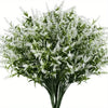 A bouquet of artificial white flowers with green foliage arranged in a vase.