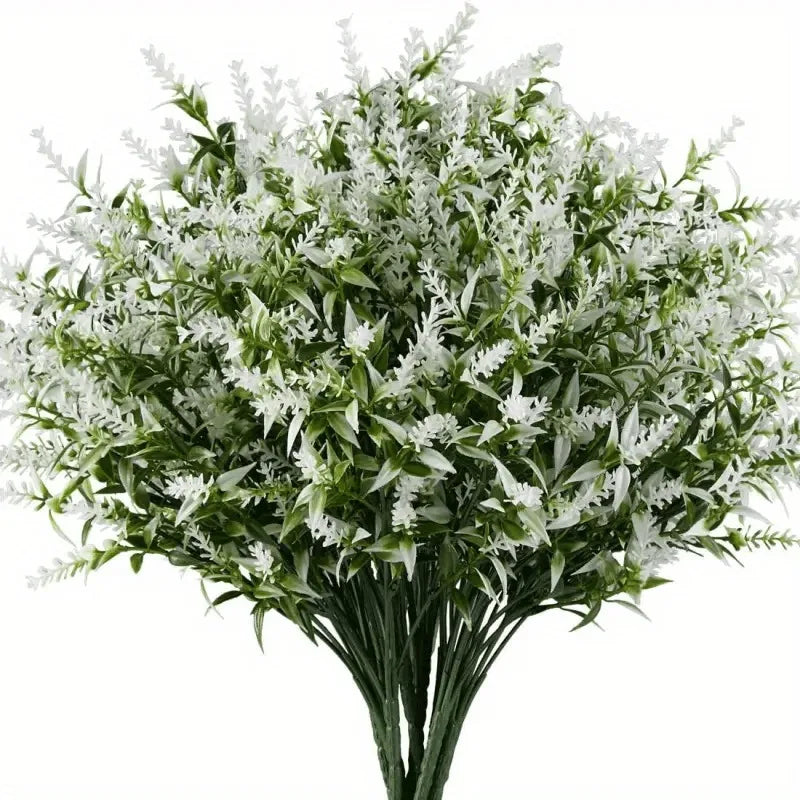A bouquet of artificial white flowers with green foliage arranged in a vase.