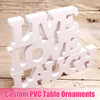 White PVC table ornaments shaped like the words LIVE LOVE LAUGH