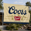 A beige flag banner with the word Coors in dark blue script above a silhouette of mountains and a red banquet logo.