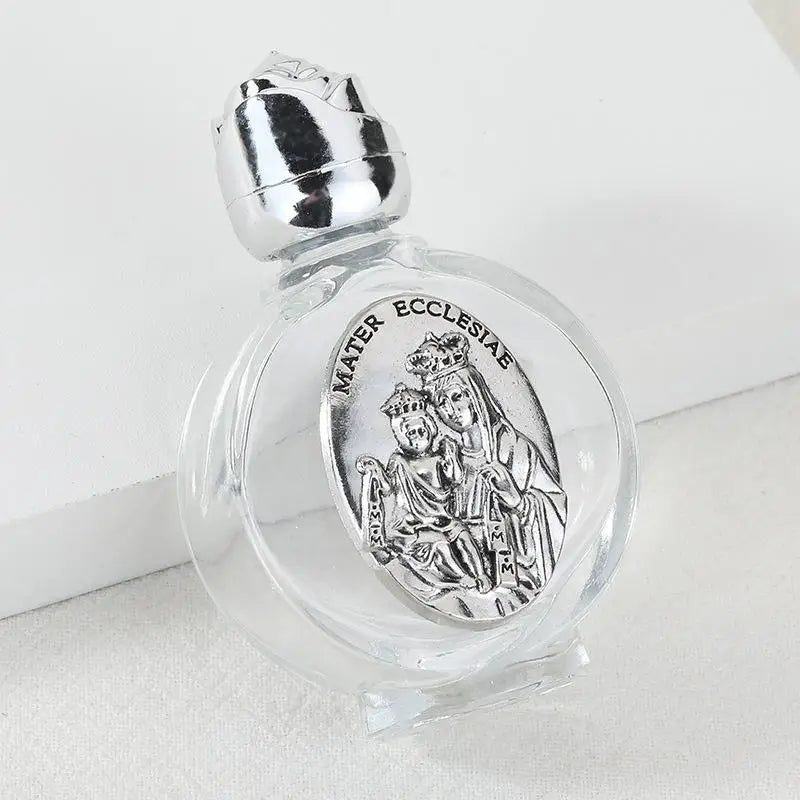 Decorative glass bottle with a silver figurine and twist cap.