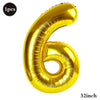 A shiny gold foil number balloon shaped like the number six.