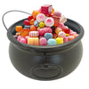 A black cauldron bowl filled with colorful, round candies and jellies.
