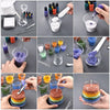 Various colors of sand pigment and wax are shown in various containers and hands for a candle making kit.