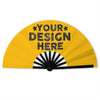 A yellow folding hand fan with the text Your Design Here printed on it.