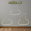Three white hat organizer racks hanging on a wall.