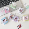 A collection of photo albums and keychains featuring cartoon hearts and images on a white background.