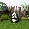 A realistic panda life cycle figurine set featuring a black and white panda sitting on green grass with bamboo in the backgro