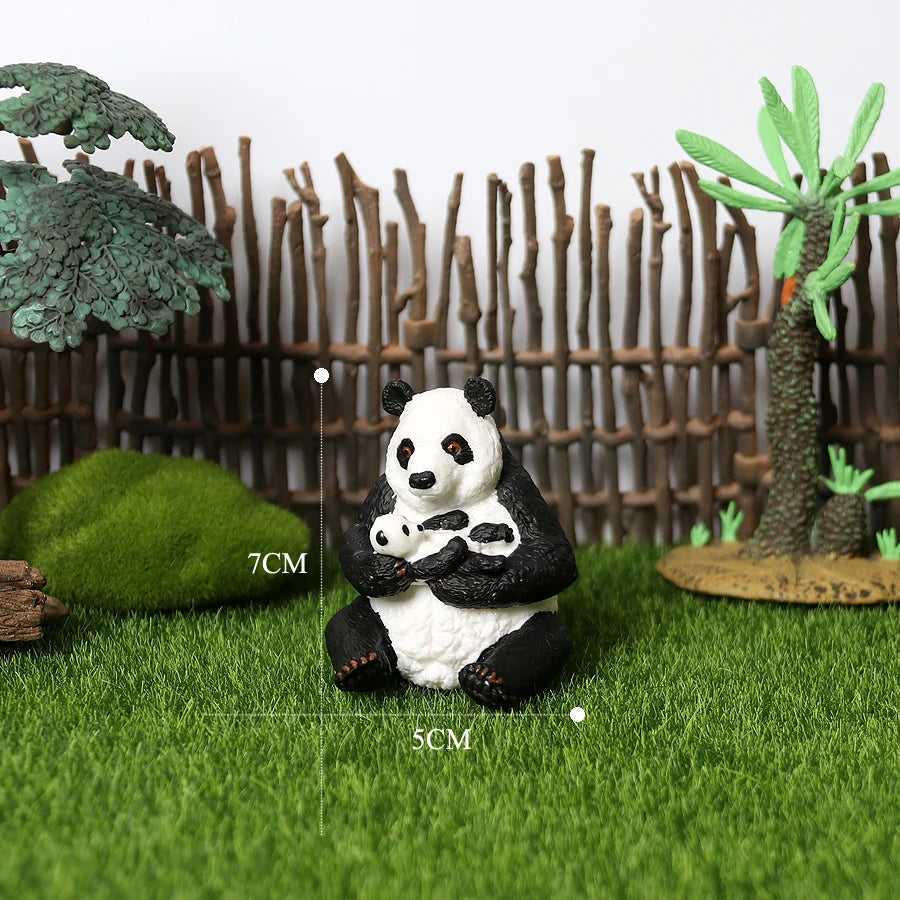 A realistic panda life cycle figurine set featuring a black and white panda sitting on green grass with bamboo in the backgro