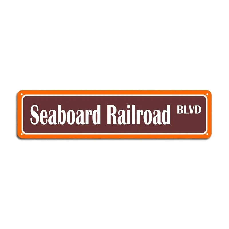 An orange rectangular metal sign with the text Seaboard Railroad BLVD.